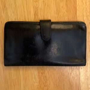 A black leather snap wallet from Coach